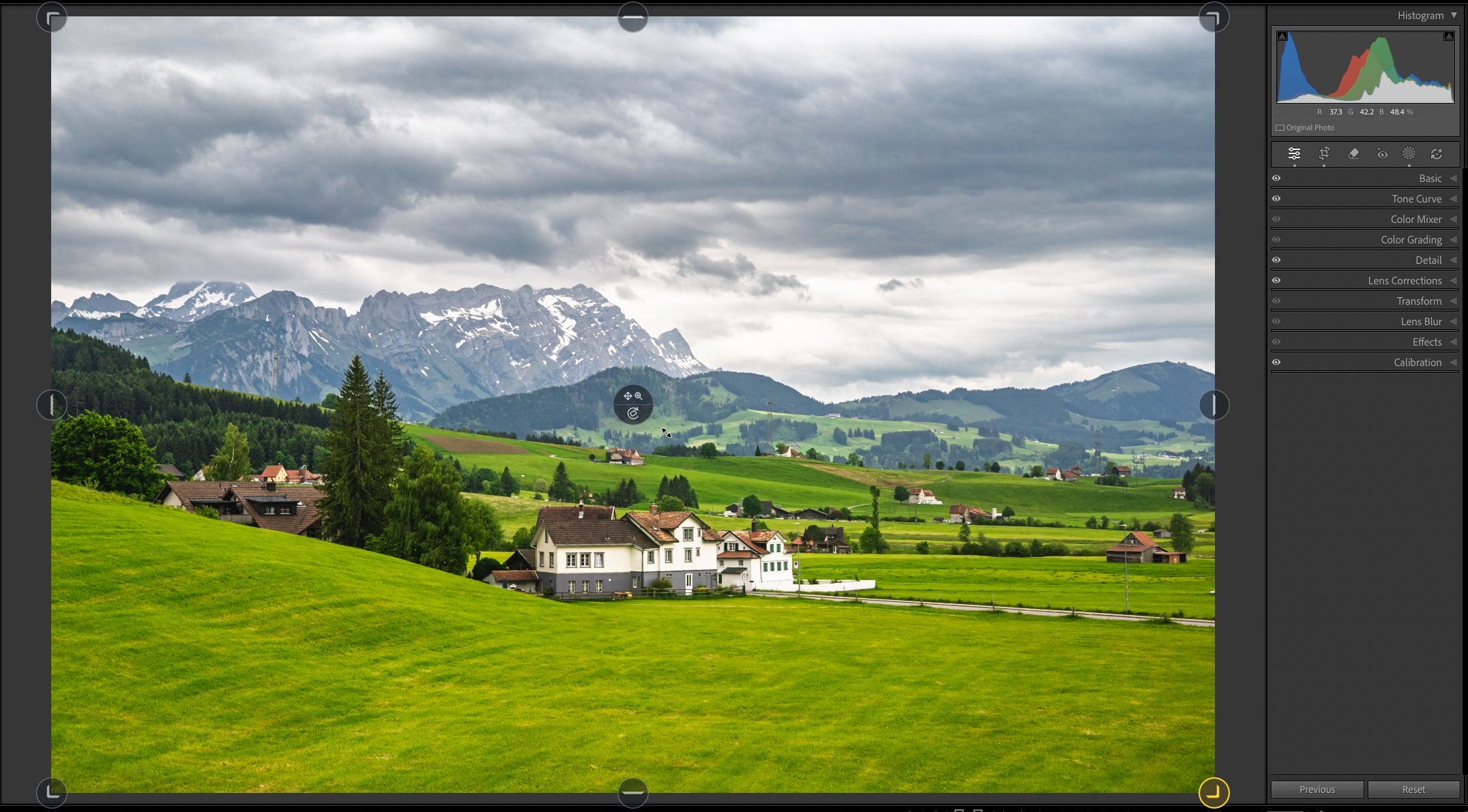 LrSK Crop Overlays around a mountain village photo, with the lower-right handle highlighted while the pointer remains near the center.